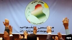 Iraq -- Members of Parliament raise their hands as they vote on a resolution, 10May2006