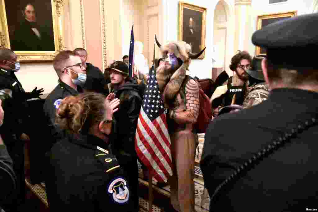 Policija se suočava sa nasilnim pristalicama predsednika SAD Donalda Trumpa dok demonstriraju na drugom spratu američkog Kapitola u blizini ulaza u Senat nakon kršenja sigurnosne odbrane, u Washingtonu, SAD, 6. januara 2021. godine. (Reuters)