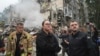 Ukrainian Prime Minister Yulia Svyrydenko (center) and Interior Minister Ihor Klymenko (right) visit the site of a multistorey residential building destroyed by a Russian missile attack in Kyiv on July 31. 