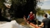 Hungarian Man Paddles To Reach Flooded Home