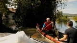 Hungarian Man Paddles To Reach Flooded Home