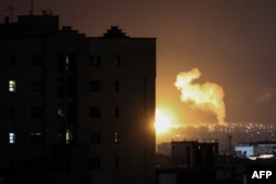 Smoke rises following air strikes in a central area of Tehran on March 6.