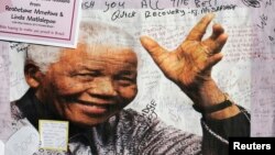 A poster of former South African President Nelson Mandela from well-wishers is filled with encouraging messages outside the Medi-Clinic Heart Hospital where he is being treated in Pretoria. 