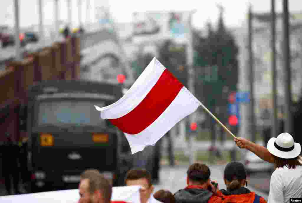 Many of the demonstrators were waving red-and-white flags and banners, which have become a symbol of the protest movement.&nbsp;