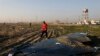 A rescue worker searches the scene where a Ukrainian plane crashed in Shahedshahr southwest of the capital Tehran, Iran, Wednesday, Jan. 8, 2020