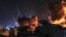 PALESTINE -- Smoke and flames rise following an Israeli air strike on Gaza City, 18 May 2021. Tensions have escalated in the region, following days of violent confrontations between Israeli security forces and Palestinians in Jerusalem, leading to the hea