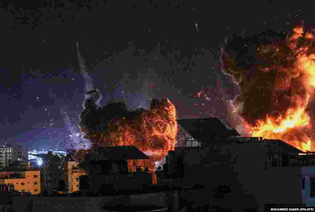 Дим і полум&#39;я піднімаються після авіаудару Ізраїлю по місту Газі 18 травня 2021 року. Ізраїль продовжив обстріл Смуги Гази невдовзі після півночі 18 травня, завдавши кілька ударів по будівлях в місті Газі