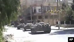 A grab taken from a DPN video shows tanks on the street in Deir el-Zour. 