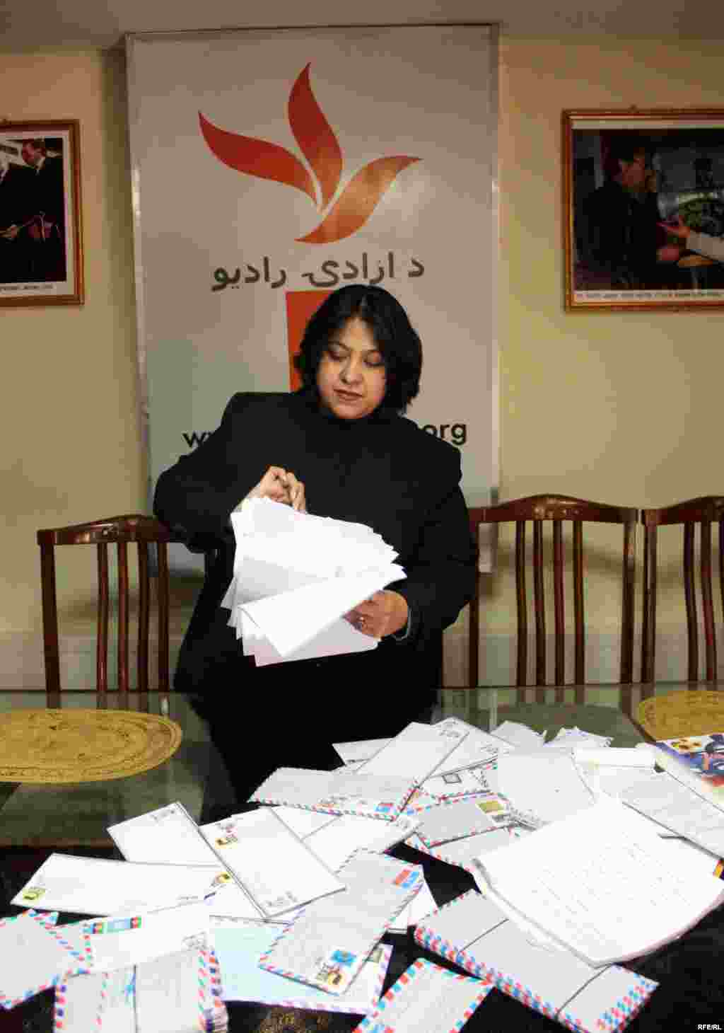 A Radio Azadi employee looks at letters sent in to the radio station by Afghan listeners