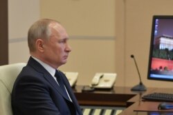 Russian President Vladimir Putin chairs a meeting with governors and officials via video link on April 8.