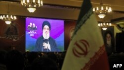 Supporters of the the Shiite Hezbollah movement watch speech of the leader Hasan Nasrallah