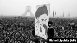 In this Dec. 10, 1978 file photo, demonstrators hold up a poster of exiled Muslim leader Ayatollah Ruhollah Khomeini during an anti-shah demonstration in Tehran, Iran. Khomeini would soon return to establish a religious authoritarian regime.