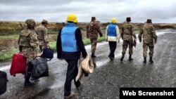 Nagorno-Karabakh - Armenian officers escort the U.S., Russian and French co-chairs of the OSCE Minsk Group on the Line of Contact northeast of Karabakh, 27Oct2015. (A screenshot of a Twitter post by James Warlick.)