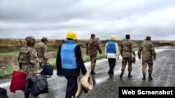 Nagorno-Karabakh - Armenian officers escort the U.S., Russian and French co-chairs of the OSCE Minsk Group on the Line of Contact northeast of Karabakh, 27Oct2015. (A screenshot of a Twitter post by James Warlick.)