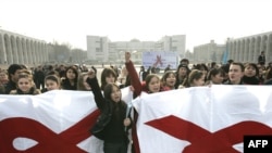 Kyrgyz students in Bishkek hold banners with red ribbons to symbolize AIDS awareness on World AIDS Day.