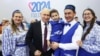 Russian President Vladimir Putin (center) poses with participants of the Russian Family Forum's Relatives and Loved Ones event in Moscow on January 23, 2024.