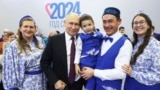 Russian President Vladimir Putin (center) poses with participants of the Russian Family Forum's Relatives and Loved Ones event in Moscow on January 23, 2024.