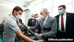 Armenia -- A worker shows Prime Minister Nikol Pashinian a Kalashnikov AK-103 rifle assembled at the Neitron company plant in Abovian, July 7, 2020.