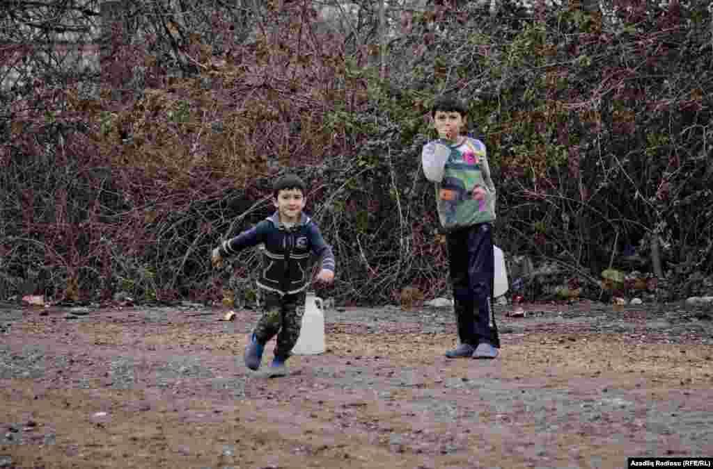 Evlərinə içməli su daşıyan kənd uşalqları.