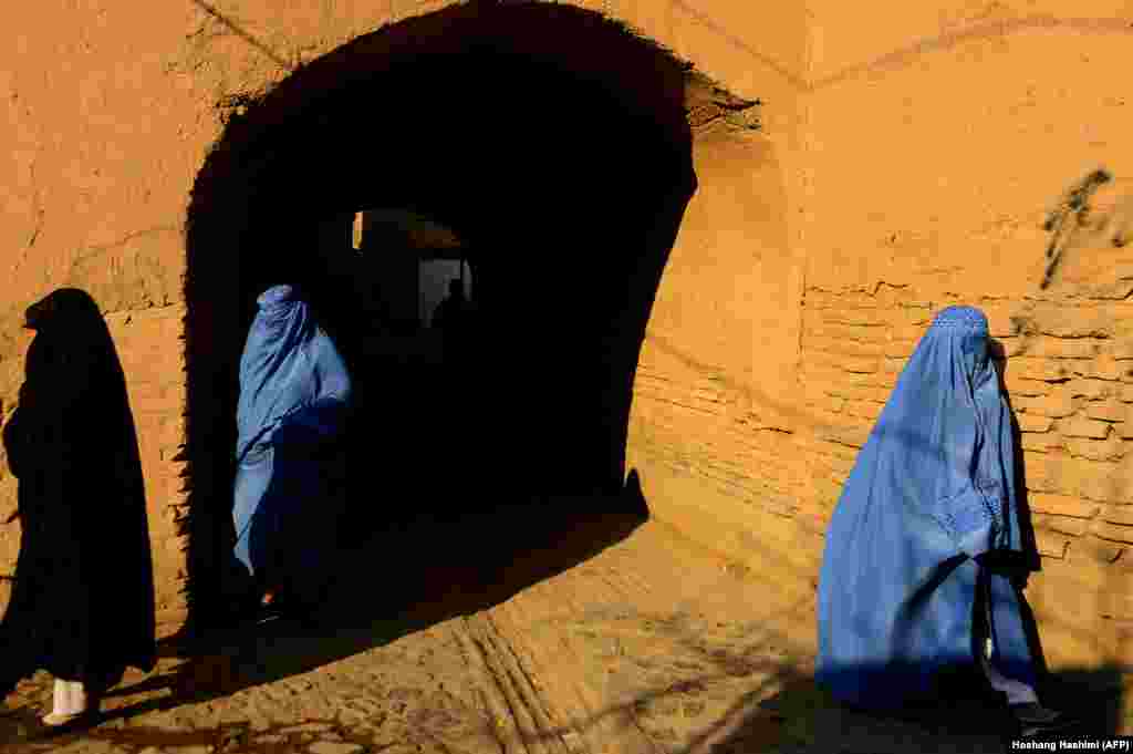 Burqa-clad Afghan women walk in the old part of Herat. (AFP/Hoshang Hashimi)