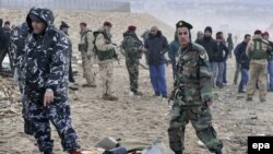 Soldiers and civilian defense workers collect debris from the Ethiopian Airlines plane.