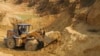 A worker drives a skip loader while working at the site of a rare earth metals mine in China. (file photo)