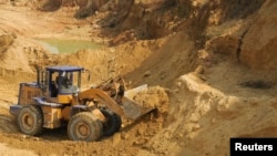 A worker drives a skip loader while working at the site of a rare earth metals mine in China. (file photo)