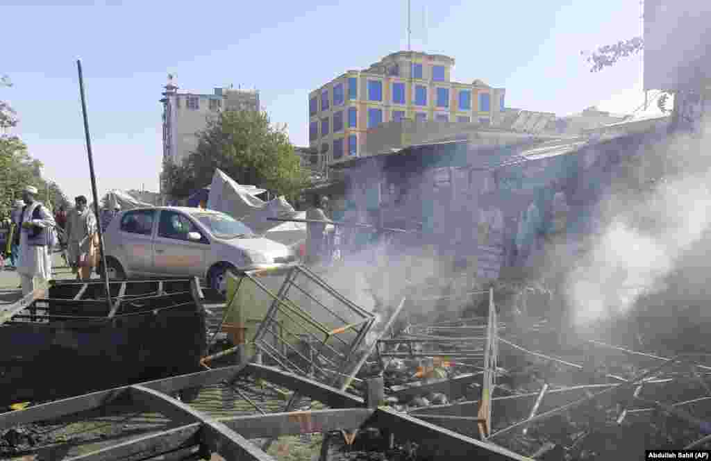 Smoke rises from damaged shops in Kunduz. The Afghan Defense Ministry denied Kunduz had fallen, saying in a statement on August 8 that commandos launched a clearance operation in the city, adding that the main intersection in the city center had been recaptured and the national TV building cleared of Taliban fighters.