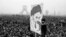 In this Dec. 10, 1978 file photo, demonstrators hold up a poster of exiled Muslim leader Ayatollah Ruhollah Khomeini during an anti-shah demonstration in Tehran, Iran. Khomeini would soon return to establish a religious authoritarian regime.
