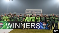 د پاکستان لوبغاړي له سري لنکا څخه د لوبلړۍ تر ګټلو وروسته له جام سره د عکس اخیستو پر مهال - د نومبر ۱۶مې انځور. 