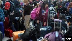 Italian tourists rest in the departure hall of Prague's Ruzyne Airport.