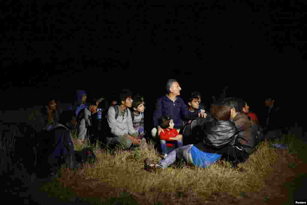 Syrian migrants wait after being stopped by Serbian border police near the Macedonian border. Serbia has seen a sharp rise in the number of Syrian migrants fleeing the war in their home country.&nbsp; 