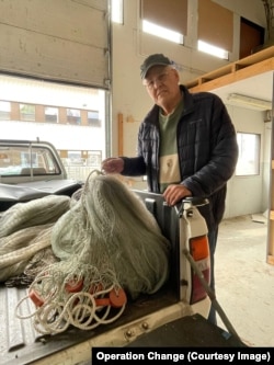 A fisherman on Aland photographed with his donated nets
