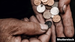 RUSSIA – Concept poverty in Russia, people of CIS. Old hands hold ruble