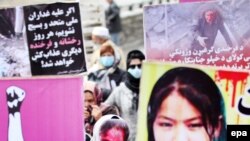 An Afghan woman wears a mask of Farkhunda Malikzada, who was stoned to death by a mob, Kabul, March 17.