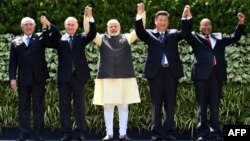 Brazilian President Michel Temer (left to right), Russian President Vladimir Putin, Indian Prime Minister Narendra Modi, Chinese President Xi Jinping, and South African President Jacob Zuma pose for a group photo during the BRICS summit in October 2016.