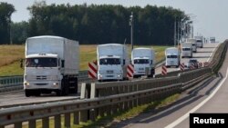 A Russian convoy of trucks bound for Ukraine drives along a road near the city of Yelets, Russia, on August 12.