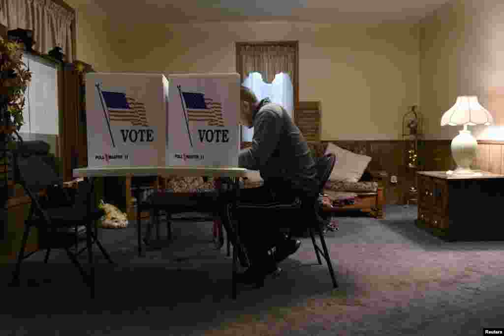 A voter fills out his ballot in a living room polling location in Dover, Oklahoma.