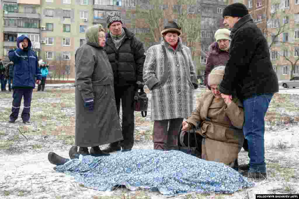 A donyecki és a luhanszki szakadár erők és az ukrán kormány között dúló kelet-ukrán háborúban becslések szerint több mint tizenháromezren vesztették életüket. Ezen a 2015-ös fényképen a bombázásokban elhunyt szerettüket gyászolják Kramotorszkban