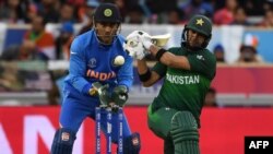 Pakistan's Rahat Ali (right) plays a shot watched by India's Mahendra Singh Dhoni during their Cricket World Cup group stage match in Manchester on June 16. 