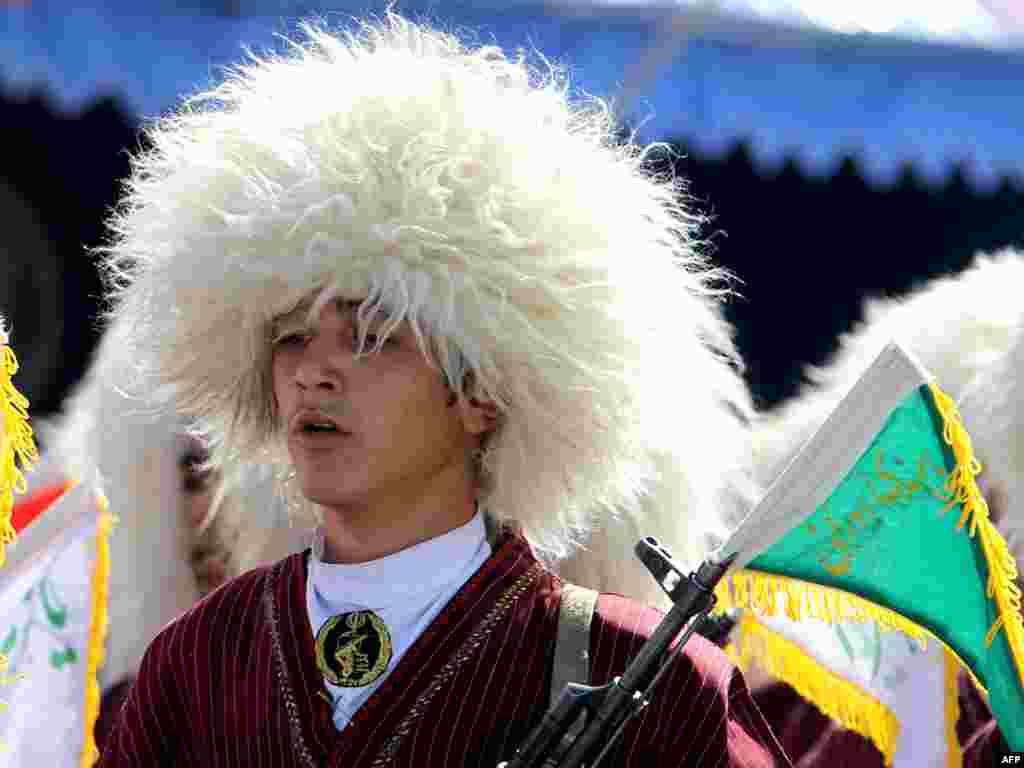 An ethnic Turkmen member of the Basij militia marches during an annual military parade to mark Iran's eight-year war with Iraq in the capital Tehran on September 22. At least nine people were killed in an attack on a provincial military parade, marking the same occasion. Photo by Atta Kenare for AFP
