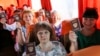 Ukraine -- In this photo taken on Saturday, June 27, 2020, people show their Russian passports sitting on a a bus to Russia at a bus stop in Donetsk, eastern Ukraine.27Jun2020