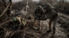 Ukrainian sappers of the 24th Mechanized Brigade carry an unexploded shell as they inspect an area for mines near the town of Chasiv Yar, Donetsk region, on January 10. 