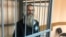 Andrei Vinarsky in the defendants cage in a court in Khabarovsk on May 13. 