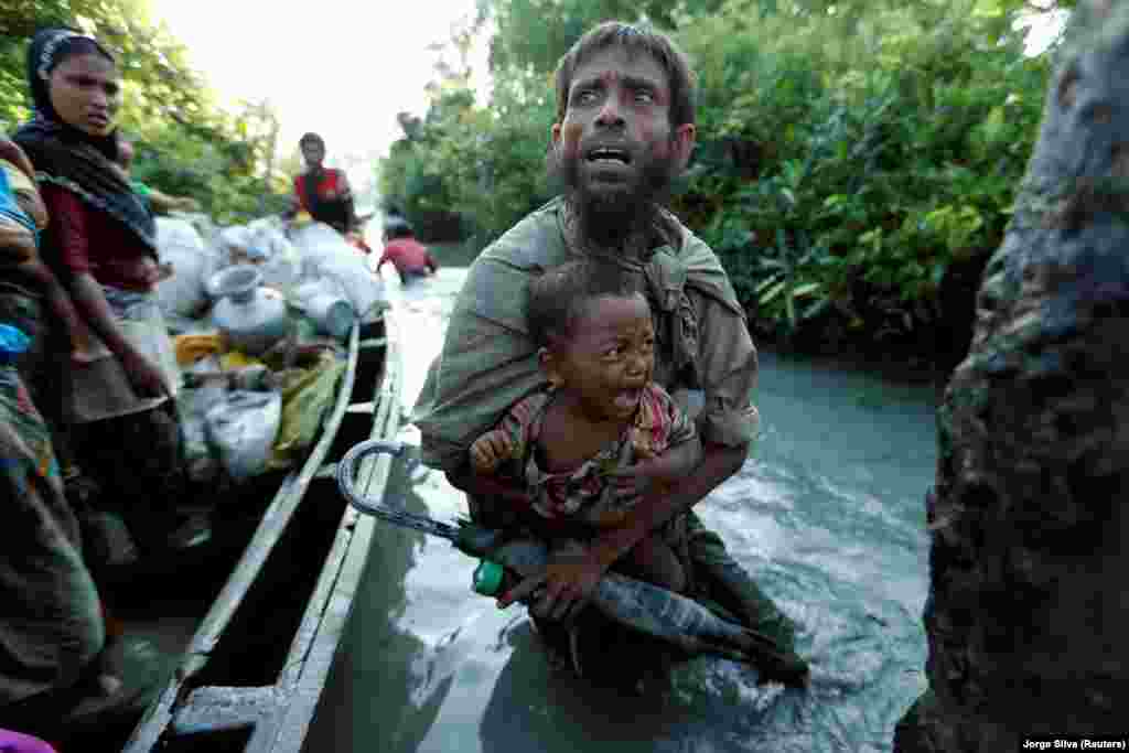 Rohingya refugees arrive on the Bangladeshi side of the Naf River after crossing the border from Myanmar, in Palang Khali, Bangladesh, on October 16. (Reuters/Jorge Silva)