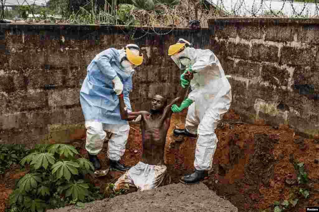 Muller, a U.S. photographer of Prime on assignment for National Geographic/The Washington Post, won First Prize in the General News Category, Stories, with his series of pictures that includes this one of medical staff at the Hastings Ebola Treatment Center escorting a man in the throes of Ebola-induced delirium back into the isolation ward from which he escaped, in Freetown.
