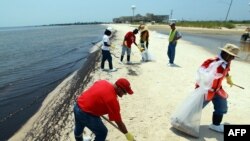 Cleanup work in July on a beach in Mississippi of oily globs that washed ashore from BP's "Deepwater Horizon" spill