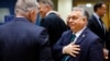 Hungarian Prime Minister Viktor Orban (right) talks to Slovak Prime Minister Robert Fico during a meeting at the EU summit in Brussels on February 1.