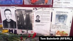 Ivan Taran's face (left) is just one of dozens that stare hauntingly out of missing-person notices on Kyiv's Independence Square.