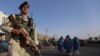 Afghan security official stands guard at a roadside checkpoint in Herat, Afghanistan, on August 3.